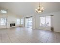 Spacious living room with tiled floors, fireplace, vaulted ceilings, and natural light from multiple windows at 11840 N 40Th Way, Phoenix, AZ 85028