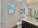 Stylish half bathroom featuring modern fixtures, white countertops and shelving with decorative accents at 12227 W Prickly Pear Trl, Peoria, AZ 85383
