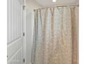 Close up of a shower with a patterned curtain and white tiled walls at 12227 W Prickly Pear Trl, Peoria, AZ 85383