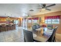 Open-concept dining area with a spacious table, ceiling fan, and access to the kitchen and living spaces at 1226 N Nevada Way, Mesa, AZ 85203