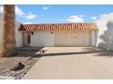 Charming single-story home showcasing a red tile roof and attached two-car garage at 13640 N Del Webb Blvd, Sun City, AZ 85351