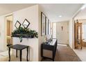 Inviting foyer with decor, mirrors, and a view of the home's entrance at 13640 N Del Webb Blvd, Sun City, AZ 85351
