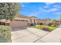 Charming single-story home with a well-manicured lawn and a spacious driveway at 16847 W Marconi Ave, Surprise, AZ 85388