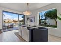 Modern dining room with a lake view, contemporary lighting, and stylish furniture at 1700 E Lakeside Dr # 16, Gilbert, AZ 85234