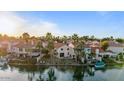 Waterfront home featuring lush landscaping, private docks, and serene views of the surrounding water at 1700 E Lakeside Dr # 16, Gilbert, AZ 85234