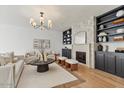 Bright living room featuring built-in shelving, a fireplace, and comfortable seating at 1700 E Lakeside Dr # 16, Gilbert, AZ 85234