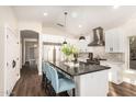 Modern kitchen with stainless steel appliances, white cabinetry, and an island with seating at 2043 E Clipper Ln, Gilbert, AZ 85234