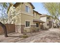 Two story tan home with stone veneer accents and a covered front entryway at 2568 E Boston St, Gilbert, AZ 85295