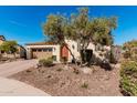 Charming single-story home with a well-manicured front yard, desert landscaping and a two car garage at 28798 N 127Th Ave, Peoria, AZ 85383