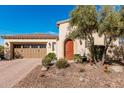 Charming single-story home with a well-manicured front yard, desert landscaping and a two car garage at 28798 N 127Th Ave, Peoria, AZ 85383