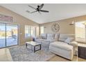 Comfortable living room featuring a plush sectional sofa, decorative rug, and natural light at 2910 E Quiet Hollow Ln, Phoenix, AZ 85024