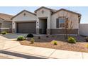 Charming single-story home with a two-car garage and a well-maintained desert landscape at 38145 W Amalfi Ave, Maricopa, AZ 85138