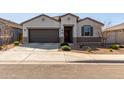 Charming single-story home with a two-car garage and a well-maintained desert landscape at 38145 W Amalfi Ave, Maricopa, AZ 85138