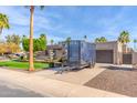 Charming single-story home featuring a well-manicured lawn, mature trees, and a private driveway with trailer at 4037 S Taylor Dr, Tempe, AZ 85282