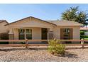 Charming single-story home featuring desert landscaping and inviting front porch with decorative wreath at 4428 E Wildhorse Dr, Gilbert, AZ 85297