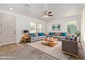 Bright living room featuring neutral decor, comfortable seating, ceiling fan, and ample natural light at 4428 E Wildhorse Dr, Gilbert, AZ 85297