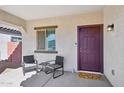 Inviting front porch with seating area and stylish front door at 45734 W Sky Ln, Maricopa, AZ 85139