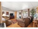 Cozy living room with a large sofa, decorative accents, and ample natural light at 7807 E Main St # Cc-85, Mesa, AZ 85207