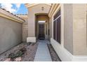 Inviting entryway with decorative glass door, stone accents, and a covered porch offering curb appeal at 8117 E Sweet Bush Ln, Gold Canyon, AZ 85118