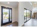 Bright entryway with sleek front door and expansive glass doors and staircase to the upper level at 8510 S 9Th Dr # 20, Phoenix, AZ 85041