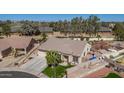 Aerial view of a single-story home boasting a well-maintained yard with mature trees and desert landscaping at 8554 W Keim Dr, Glendale, AZ 85305