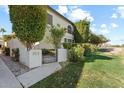 Inviting exterior of a two-story home with mature landscaping and a decorative front gate at 8813 S 51St St # 3, Phoenix, AZ 85044