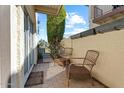 Cozy private brick patio featuring two wicker chairs, a mature tree, and blooming flowers at 8813 S 51St St # 3, Phoenix, AZ 85044