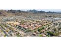 Expansive aerial view showcasing a community with tile roofs, surrounded by mountains and desert landscape at 10410 N Cave Creek Rd # 2034, Phoenix, AZ 85020