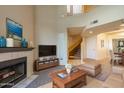 A spacious living room with a vaulted ceiling, a fireplace, and stairs to a second story at 10410 N Cave Creek Rd # 2034, Phoenix, AZ 85020