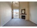 Bright living room with fireplace, high ceilings, clerestory window and sliding glass doors to balcony at 10410 N Cave Creek Rd # 2034, Phoenix, AZ 85020