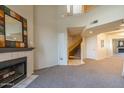 A spacious living room with a vaulted ceiling, a fireplace, and stairs to a second story at 10410 N Cave Creek Rd # 2034, Phoenix, AZ 85020