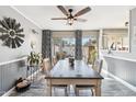 Dining room with a wooden table, six chairs, modern light fixtures and hardwood floors at 10533 W Granada Dr, Sun City, AZ 85373