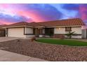 Inviting single-story home featuring desert landscaping, stone accents, and a tile roof at 11430 E Neville Ave, Mesa, AZ 85209