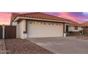 A close-up shot of a white garage door with a tile roof, offering ample space for parking at 11430 E Neville Ave, Mesa, AZ 85209