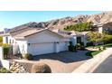 Spacious home with a three-car garage, tile roof, desert landscaping, and mountain views at 122 E Desert Wind Dr, Phoenix, AZ 85048