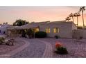 A charming home featuring low-maintenance landscaping, a brick-lined driveway, and desert plants at 12222 S Appaloosa Dr, Phoenix, AZ 85044