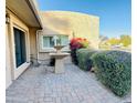 Private patio area featuring brick pavers, a water fountain, and lush landscaping for peaceful outdoor living at 13234 N 2Nd St, Phoenix, AZ 85022