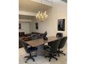 Dining area with a marble-topped table, chandelier and open layout at 150 W Tam Oshanter Dr, Phoenix, AZ 85023