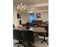 Open concept dining area featuring a marble-topped table, chandelier and seamless transition into the living room at 150 W Tam Oshanter Dr, Phoenix, AZ 85023