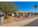 Street view of single-story home with desert landscaping and a gated carport at 15811 N 23Rd St, Phoenix, AZ 85022