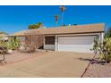 Single-story home with desert landscaping and a two-car garage and wide driveway at 15811 N 23Rd St, Phoenix, AZ 85022