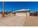 Well-maintained home featuring a two-car garage, desert landscaping, and a concrete driveway at 1715 N Sawyer --, Mesa, AZ 85207