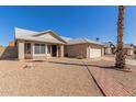 Inviting one-story home showcasing desert landscaping, a brick walkway, and a two-car garage at 1715 N Sawyer --, Mesa, AZ 85207