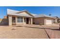 Welcoming one-story home with desert landscaping, a brick path, and an attached two-car garage at 1715 N Sawyer --, Mesa, AZ 85207