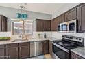 Well-lit kitchen featuring granite countertops, stainless steel appliances, and tiled backsplash at 17839 W Maui Ln, Surprise, AZ 85388