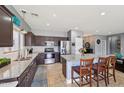 Spacious kitchen with granite countertops, stainless steel appliances, and large center island at 17839 W Maui Ln, Surprise, AZ 85388