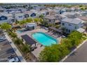 Aerial view of a community pool with seating, shade structures, and a hot tub at 1901 W 23Rd Ave, Apache Junction, AZ 85120