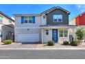Charming two-story home featuring a blue front door, two car garage, and landscaped yard at 1901 W 23Rd Ave, Apache Junction, AZ 85120
