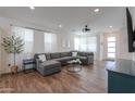 Spacious living room with wood-look tile flooring, recessed lighting, and a comfortable gray sofa at 1901 W 23Rd Ave, Apache Junction, AZ 85120