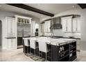 Gourmet kitchen with granite island, stainless steel appliances, and custom white cabinets with dark trim at 20299 N 102Nd Pl, Scottsdale, AZ 85255